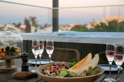 a table with wine glasses and a bowl of food at Chris Le Mare Gold Luxury Villa in Protaras