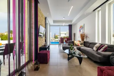a living room with a couch and a table at Mylos Lifestyle Seaview Villa #21 in Protaras