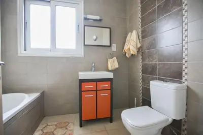a bathroom with a toilet and a sink and a tub at Apt Lasonos Asimi - Luxury 3 Bedroom Protaras Apartment - Communal Pool in Protaras
