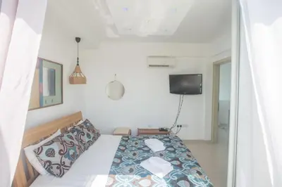 a bedroom with a bed and a tv on the wall at Sunrise Villa 12 in Ayia Napa