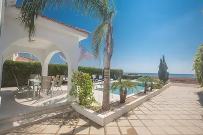 a villa with a swimming pool and palm trees at Sunrise Villa 12 in Ayia Napa