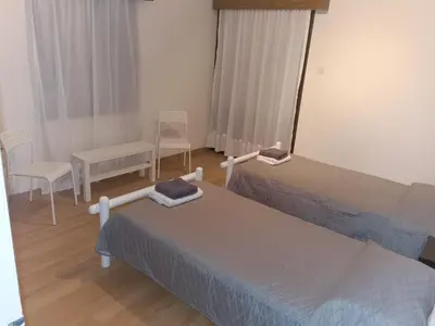 a bedroom with two beds and a table and chairs at Kakopetria Heights in Kakopetria