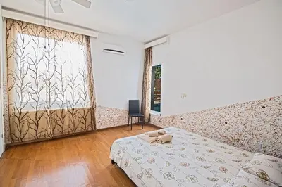 a bedroom with a bed and a large window at Villa Mavris - Lovely 4 Bedroom Villa With Private Pool In Central Ayia Napa in Ayia Napa