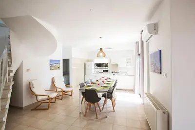 a kitchen and dining room with a table and chairs at Villa Nepou - Beautiful 4 Bedroom Villa - Located In Ayia Napa in Ayia Napa