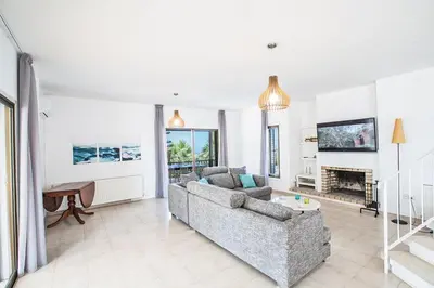 a living room with a couch and a fireplace at Villa Nepou - Beautiful 4 Bedroom Villa - Located In Ayia Napa in Ayia Napa