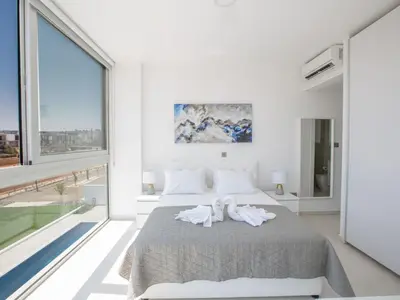 a white bedroom with a bed with towels on it at Villa Manta Agrotikos - Stunning 3 Bedroom Protaras Villa With Pool in Protaras