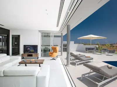 a living room with white furniture and a pool at Villa Manta Agrotikos - Stunning 3 Bedroom Protaras Villa With Pool in Protaras