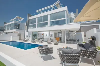 a large house with a swimming pool in front of it at Villa Manta Agrotikos - Stunning 3 Bedroom Protaras Villa With Pool in Protaras