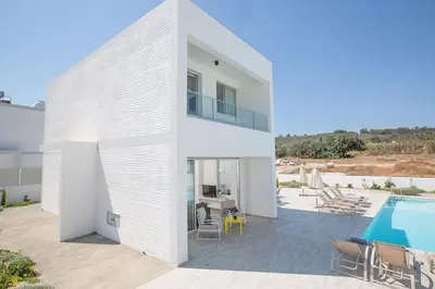 a large white house with a swimming pool at Villa Ochosto Eos - Luxury 5 Bedroom Protaras Villa With Private Pool - Close in Protaras