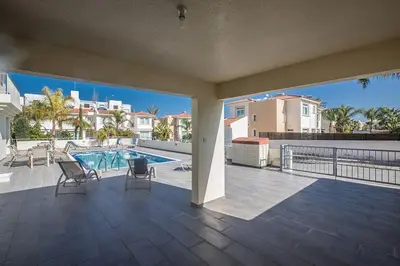 a balcony with a view of a swimming pool at Villa Dafnis Platina - Lovely 4 Bedroom Protaras Villa With Private Pool in Protaras