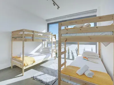 two bunk beds in a room with a window at Villa Limni Dyo - Luxurious Contemporary 3 Bedroom Villa With Sea Views And Hot in Paralimni