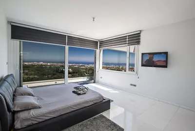 a bedroom with a bed and a large window at Villa Saranta Gold - Exquisite 3 Bedroom Protaras Villa With Private Pool in Protaras