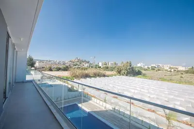 a balcony of a building with a view of the water at Villa Olive Titan, Brand New,Exquisite 5Bdr Protaras Villa With Pool in Protaras