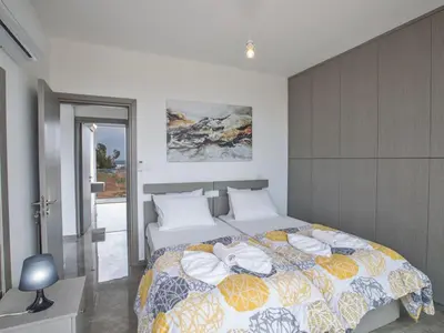 a bedroom with a large bed with towels on it at Villa Olive Bronze, Luxurious 2Bdr With Pool, Close To Protaras Strip And Beach in Protaras