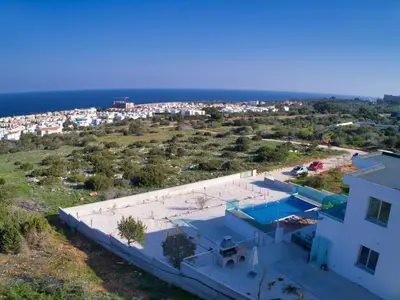 an aerial view of a house and the ocean at Villa Kono Provoles - Luxury 4 Bedroom Protaras Villa With Stunning Panoramic in Protaras