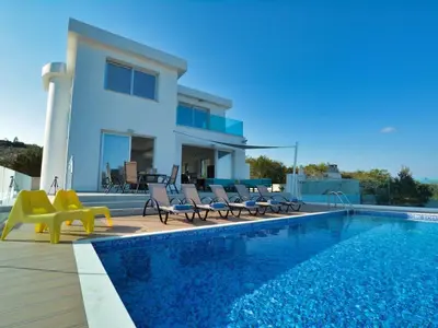 a villa with a swimming pool next to a house at Villa Kono Provoles - Luxury 4 Bedroom Protaras Villa With Stunning Panoramic in Protaras