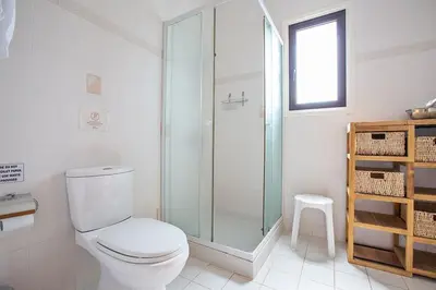 a bathroom with a toilet and a glass shower at Villa Kanthos - Beautiful 4 Bedroom Protaras Villa With Pool in Protaras