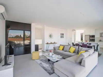a living room with a couch and a table at Villa Panemorfi - Luxury Brand New 3 Bedroom Protaras Villa With Private Pool in Protaras