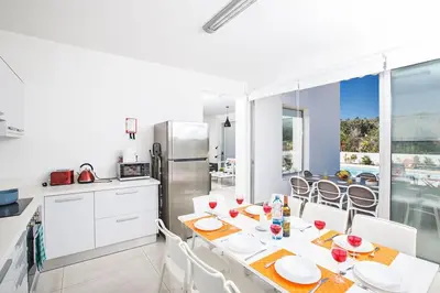 a kitchen and dining room with a table and chairs at Villa Ochosto Selene - Stunning 5 Bedroom Protaras Villa With Private Pool in Protaras