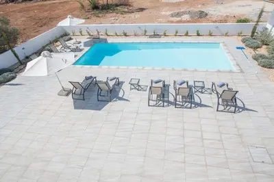 a group of chairs and a swimming pool at Villa Ochosto Loux - Fabulous 5 Bedroom Protaras Villa With Private Pool in Protaras