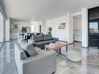 a living room with two couches and a table at Villa Manta Chrysos - Brand New Luxury 3 Bedroom Protaras Villa in Protaras