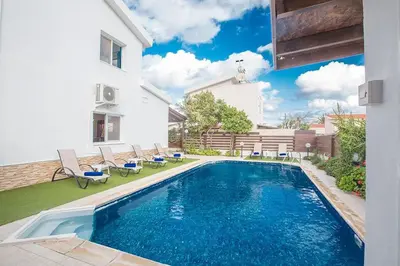 a swimming pool in the backyard of a house at Villa Kavo Sunshine - Beautiful 3 Bedroom Protaras Villa With Private Pool in Protaras