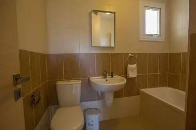 a bathroom with a toilet and a sink at Central Protaras Villa 3 Bedrooms Private Pool Villa Dafnis Morfi in Protaras