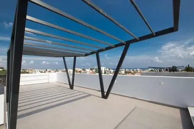 a roof deck with a view of the city at Villa Apomono - New Luxury 3 Bedroom Protaras Villa With Pool in Protaras