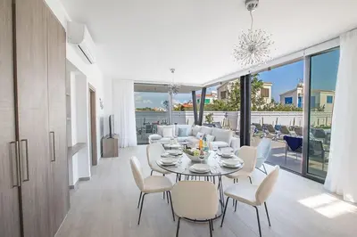 a dining room with a table and chairs at Villa Apomono - New Luxury 3 Bedroom Protaras Villa With Pool in Protaras