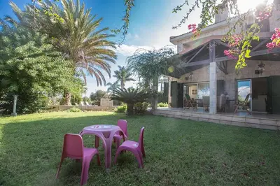 a table and chairs in the yard of a house at Villa Matronas Titan - Stunning 5 Bedroom Protaras Villa With Private Pool in Paralimni