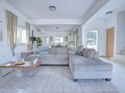 a living room with a couch and a table at Villa Oforo Selene - Stunning 4 Bedroom Villa - By Fig Tree Bay Beach - Sea View in Protaras