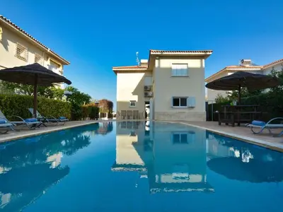 a swimming pool in front of a villa at Villa Oforo Selene - Stunning 4 Bedroom Villa - By Fig Tree Bay Beach - Sea View in Protaras