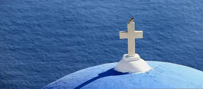 a bird sitting on top of a cross on top at Villa Mesogi, Modern 3Bdr Protaras Villa, Close To Fig Tree Bay Beach in Protaras