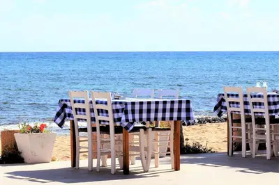 a table and chairs sitting on the beach at Villa Mesogi, Modern 3Bdr Protaras Villa, Close To Fig Tree Bay Beach in Protaras