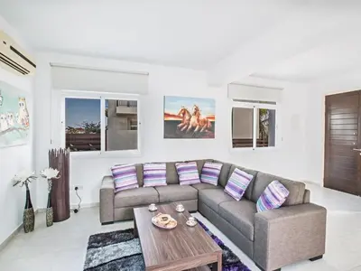 a living room with a couch and a table at Villa Mesogi, Modern 3Bdr Protaras Villa, Close To Fig Tree Bay Beach in Protaras