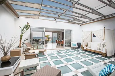 a living room with a blue and white floor at Villa Fig Tree Bay Seafront, Luxury 5Bdr Seafront Protaras in Protaras