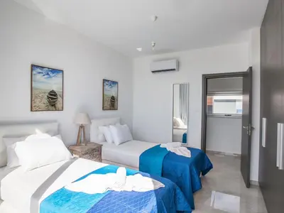 a hotel room with two beds and a couch at Villa Olive Sun, Beautiful, Contemporary 3Bdr Villa With Private Pool in Protaras
