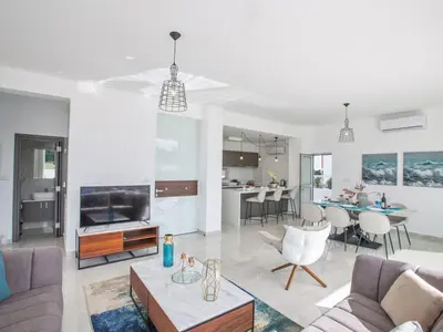 a living room with a couch and a table at Villa Olive Sun, Beautiful, Contemporary 3Bdr Villa With Private Pool in Protaras