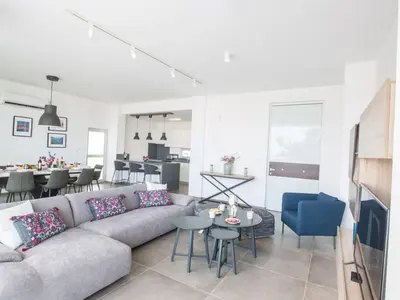 a living room with a couch and a table at Villa Olive Platinum, New And Luxury 4Bdr Protaras Villa With Private Pool in Protaras