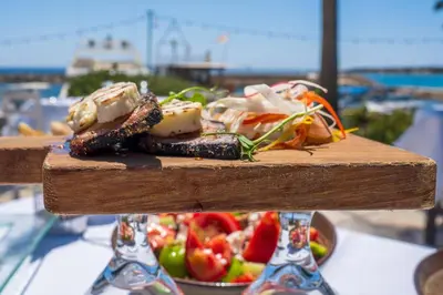 a plate of food on a table with a salad at Villa Leoforos Dyo, Modern 3Bdr Protaras Villa With Pool, In The Centre in Protaras