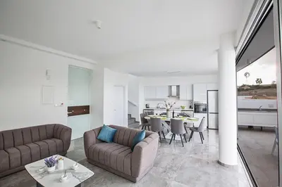 a living room with two couches and a table at Villa Olive Gold, Luxury And Brand New 2Bdr Protaras Villa With Private Pool in Protaras