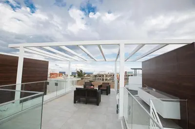 a balcony with a retractable pergola on a building at Villa Olive Gold, Luxury And Brand New 2Bdr Protaras Villa With Private Pool in Protaras