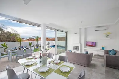 a living room with a table and chairs at Villa Olive Gold, Luxury And Brand New 2Bdr Protaras Villa With Private Pool in Protaras