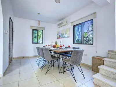 a dining room with a table and chairs at Villa Protaras Paralia Spacious 4Bdr Central Protaras Villa in Protaras