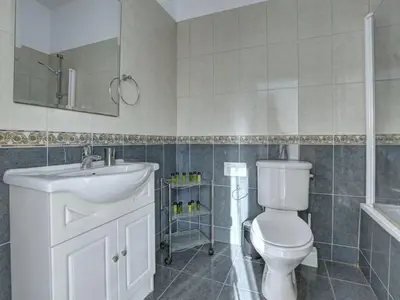 a bathroom with a toilet and a sink and a mirror at Villa Protaras Paralia Spacious 4Bdr Central Protaras Villa in Protaras