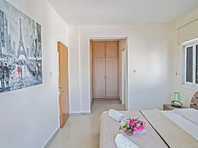 a bedroom with a bed and a painting on the wall at Villa Mesogi Seafront, Stunning 4Bdr Fontline Protaras in Protaras