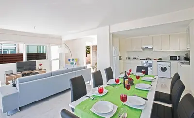 a dining room and kitchen with a table and chairs at Villa Mesogi Seafront, Stunning 4Bdr Fontline Protaras in Protaras