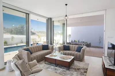a living room with two couches and a table at Villa Olive Chrysos, Brand New, Luxury 3 Bdr Protaras Villa, With Private Pool in Protaras