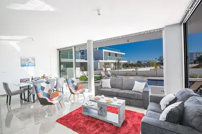 a living room with a couch and a table at Villa Olive Loux,Brand New, Exquisite 5Bdr Protaras Villa With Pool in Protaras