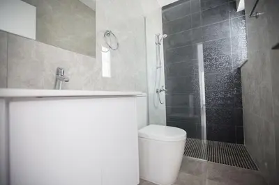 a bathroom with a shower and a toilet and a sink at Villa Olive Loux,Brand New, Exquisite 5Bdr Protaras Villa With Pool in Protaras